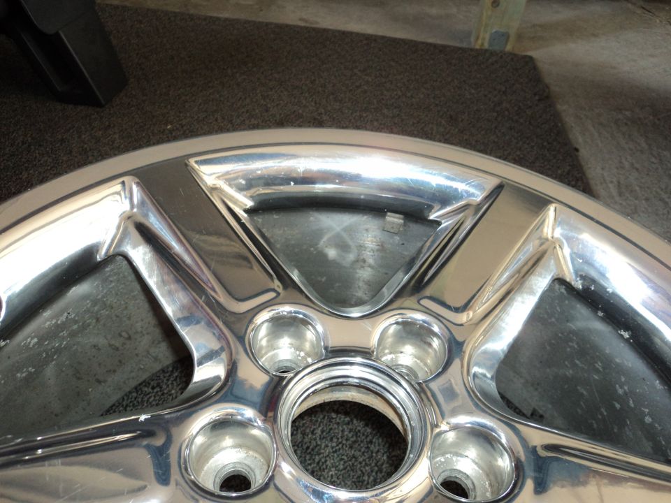 Chrome alloy wheel with five spokes, center bore visible
