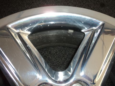 2004 Mercury Grand Marquis - A close-up view of a chrome wheel shows signs of wear and tear, with a Supermotors.net logo in the corner.