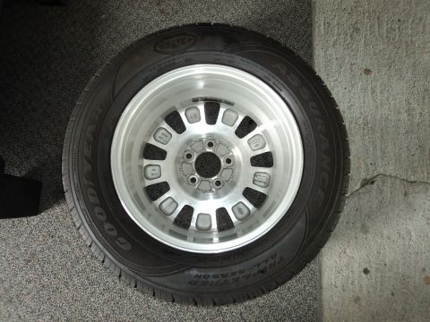 2004 Mercury Grand Marquis - A silver alloy wheel with a Goodyear Assurance All-Season tire is shown.