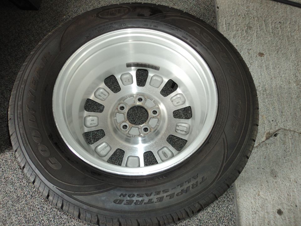 Goodyear Triple Tread All-Season tire mounted on a silver alloy wheel