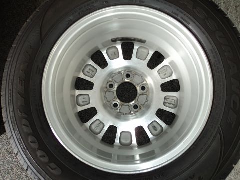 2004 Mercury Grand Marquis - A close-up view of a single car wheel and tire, with visible text on the tire's sidewall.