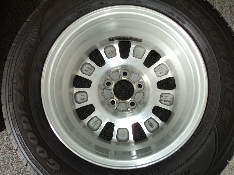 Close-up of a silver alloy wheel with a Goodyear tire. Some text is visible on the wheel and tire