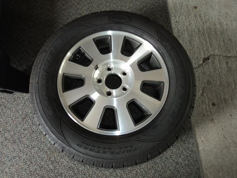 2004 Mercury Grand Marquis - A close-up view of a single wheel and tire assembly, likely from a sedan.