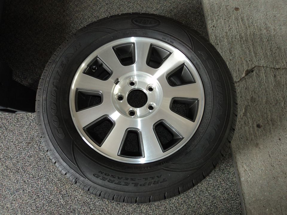 Aluminum alloy wheel with eight spokes and a Goodyear Triple-Tred All-Season tire