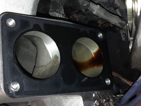 1989 Ford Bronco - Close-up of an engine intake manifold gasket, revealing internal wear and oil accumulation within the passages.