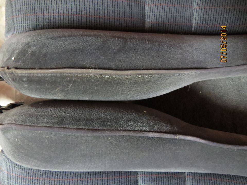 Dark gray car seat bolsters with striped fabric in background. Date stamp 07/05/2014 visible