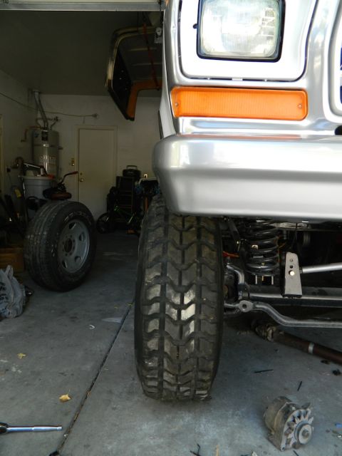 1979 Ford Bronco - Close-up of the front tire and suspension of a 1979 Ford Bronco.