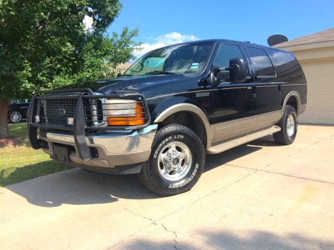 2000 Ford Excursion - Front 3/4 view of a black 2000 Ford Excursion SUV parked on a driveway.