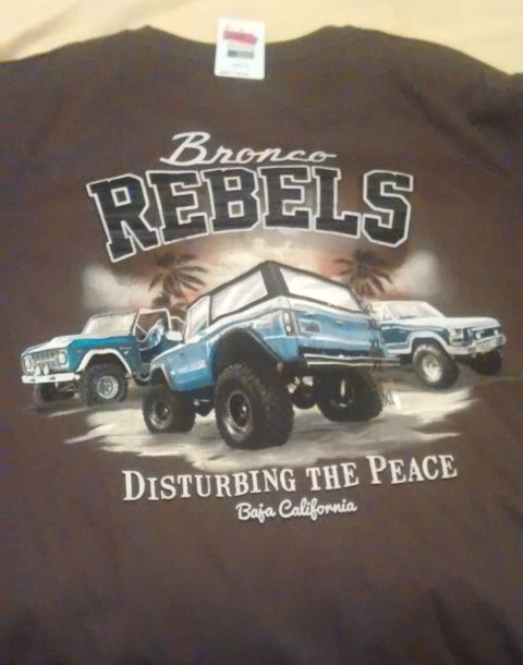 2006 Ford E350 - Graphic on a t-shirt depicts multiple Ford Broncos in a desert scene with text.
