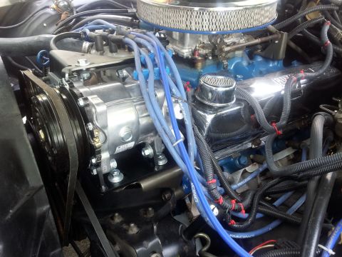1976 Ford Ranchero - Close-up view of an engine bay, highlighting the air conditioning compressor and associated plumbing.