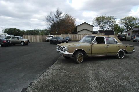 1964 AMC Javelin - This 1964 AMC Rambler American sedan is seen parked outdoors, showing signs of age and wear.