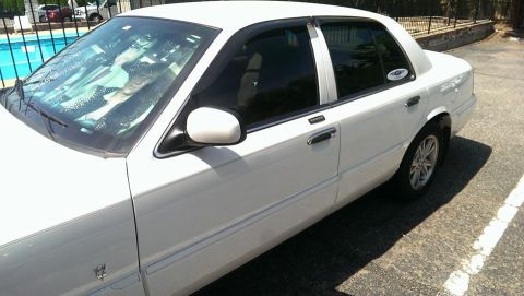 2000 Mercury Grand Marquis - A white 2000 Mercury Grand Marquis is shown from the front three-quarter view.