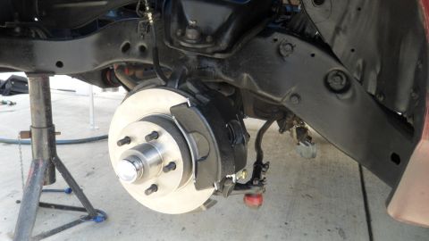 1972 Ford Ranchero - Close-up view of a vehicle's suspension and brake system, with the wheel removed.