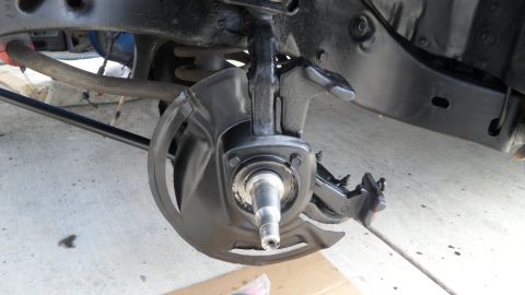 1972 Ford Ranchero - Close-up view of a vehicle's front suspension component, including the brake dust shield and spindle.