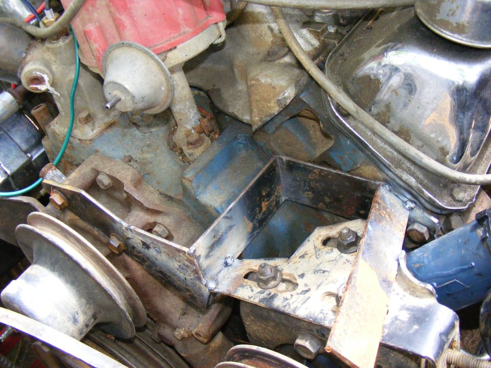 Engine bay with rusty metal brackets and pulleys