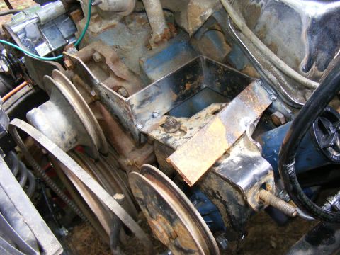 Engine bay with custom metal bracket and pulleys