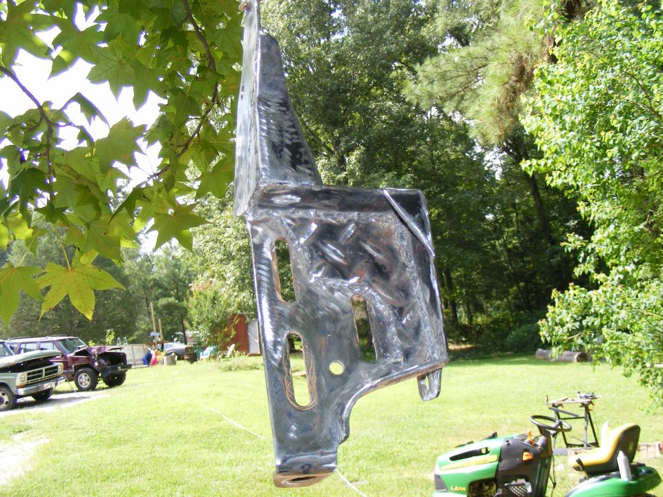 Shiny metal part hanging from tree branch