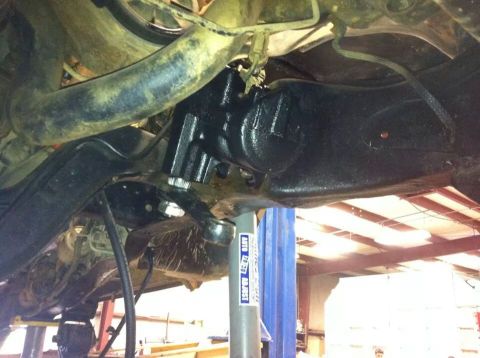 1988 Ford Bronco - Close-up view of the steering gear and suspension components from underneath a vehicle.