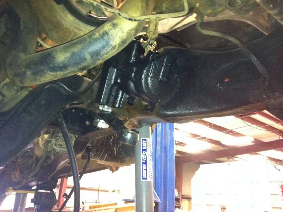 Underside view of black painted steering gear and suspension components