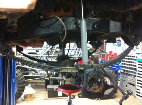 1988 Ford Bronco - The undercarriage of a vehicle is shown, focusing on the suspension components and frame.