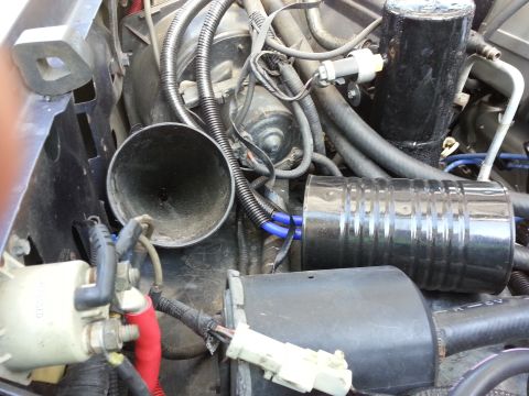 1994 Ford Bronco - Close-up view of a vehicle's engine bay, showing complex wiring and plumbing.