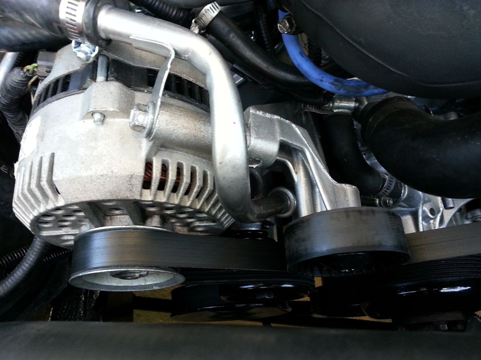 alternator, pulleys, and serpentine belt system in engine bay