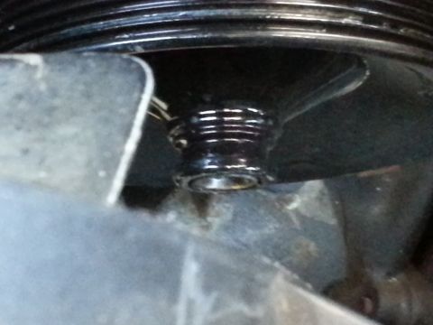 1994 Ford Bronco - A close-up view of a ribbed metal engine component with a threaded shaft, likely from a vehicle's engine.