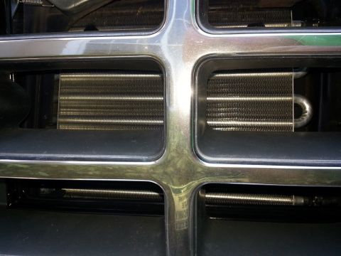 1994 Ford Bronco - Radiator or condenser fins are visible behind the vehicle's front grille.