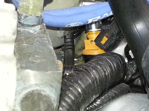 1994 Ford Bronco - Engine compartment detail showing a fuel injector and associated hoses and wiring.