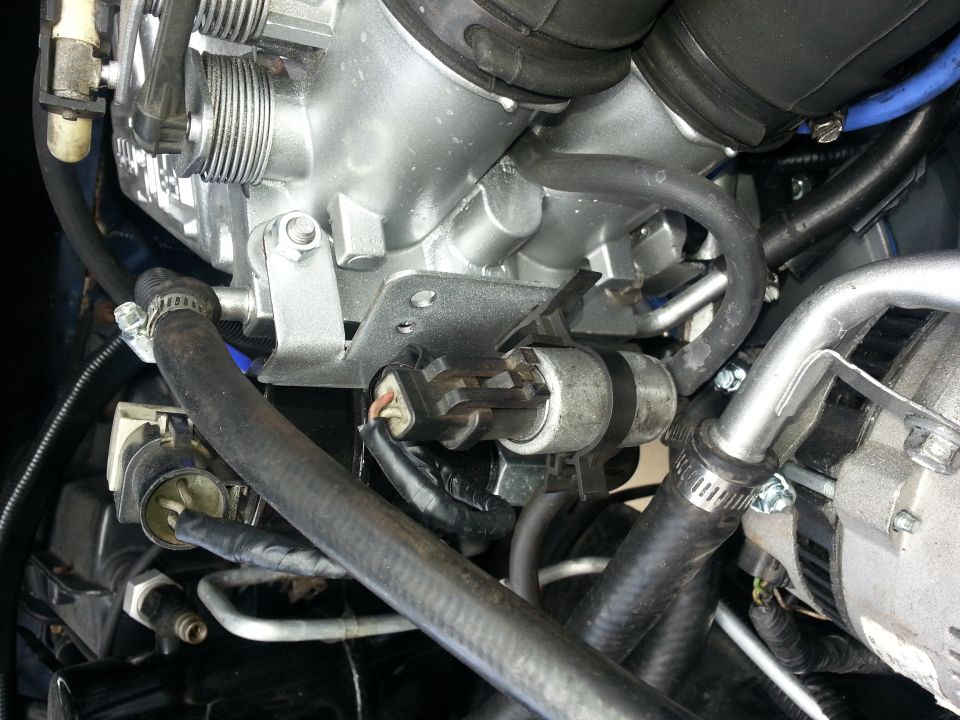 Engine components including throttle body, hoses, and a sensor