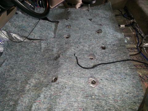 1994 Ford Bronco - The vehicle's interior carpet has been removed, revealing the floor and wiring beneath.