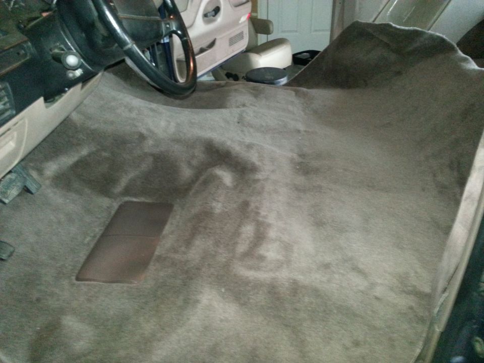 Interior carpet with steering wheel and door panel visible