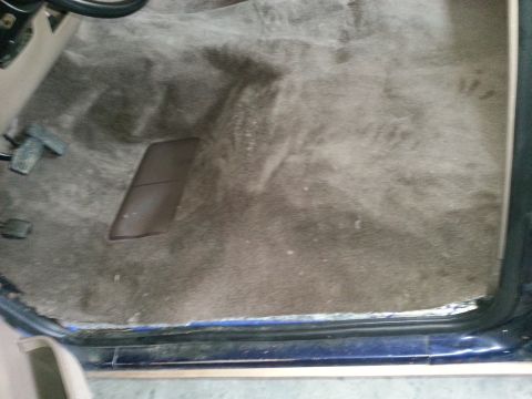 1994 Ford Bronco - Close-up view of the interior carpet and floor pedals.