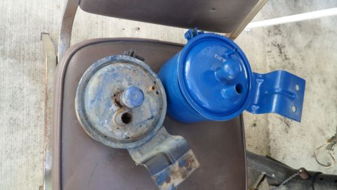 1972 Ford Ranchero - A comparison of old and new fuel filters, one showing significant wear and the other recently painted.