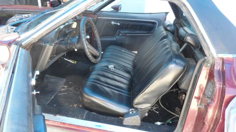 1972 Ford Ranchero - The interior of a 1972 Ford Ranchero shows a black vinyl bench seat and dashboard, with a screwdriver on the floor.