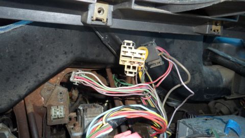 1972 Ford Ranchero - A complex network of wires and connectors is visible behind the dashboard of a vehicle.