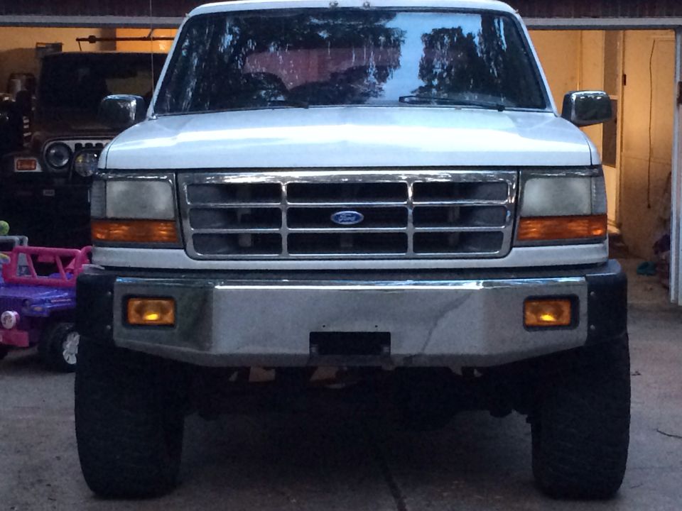 White 1994 Ford Bronco front view with chrome grille and orange turn signals