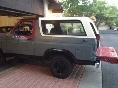 1982 Ford Bronco - This Ford Bronco is parked in a garage with its tailgate open, showing the interior.