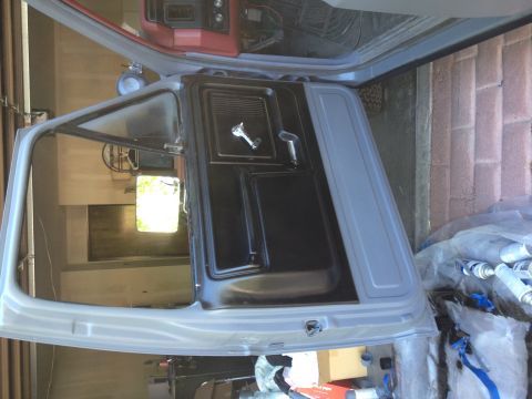 1982 Ford Bronco - The interior of a vehicle is shown, with a focus on the door panel and window frame, possibly during restoration.
