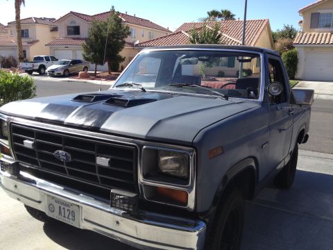 1982 Ford Bronco - This pickup truck features a distinctive grille and hood scoops, with a Nevada license plate visible.