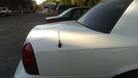 2000 Mercury Grand Marquis - A white sedan is parked in a lot, showing its rear quarter panel and antenna.
