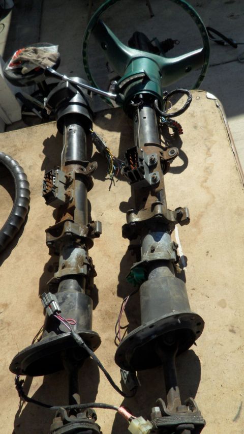 1972 Ford Ranchero - Two disassembled steering columns are laid out on a surface, showing their internal components and wiring.