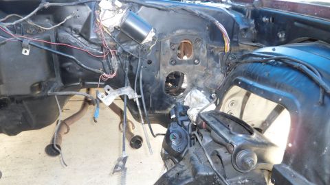 1972 Ford Ranchero - The engine bay of a vehicle is shown with exposed wiring and components, suggesting a project or repair in progress.