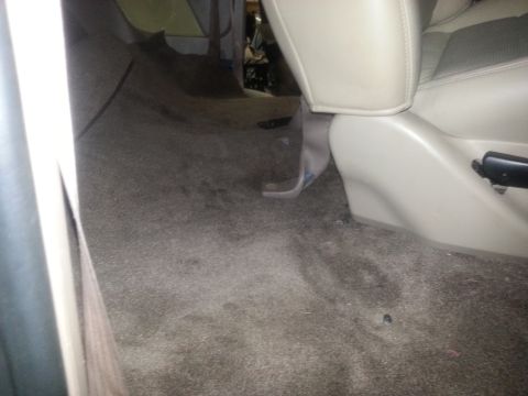 1994 Ford Bronco - The worn carpet and seat base are visible inside the vehicle's interior.