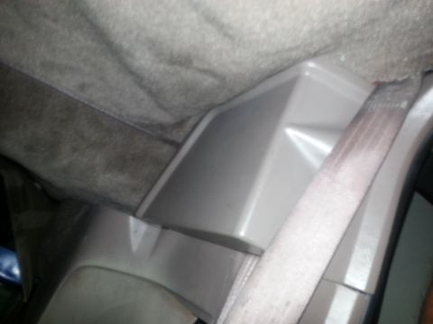 1994 Ford Bronco - Close-up of a vehicle's interior trim panel and seatbelt.