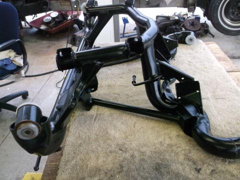 1967 Ford Mustang - A black painted subframe assembly is shown, possibly undergoing restoration or repair.