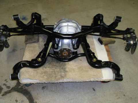 1967 Ford Mustang - A rear axle assembly, likely from a classic car, is shown with its suspension components and differential.