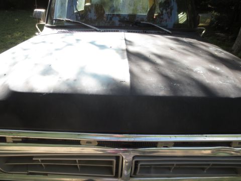 1978 Ford Bronco - Front view of a 1978 Ford Bronco showing the hood and grille, with the hood in primer and black paint.