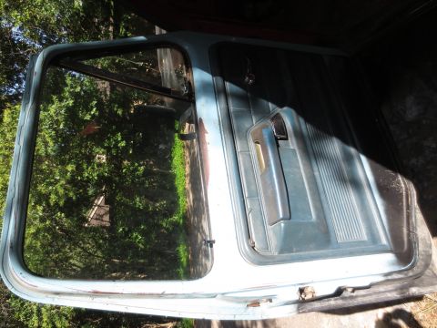 1978 Ford Bronco - A detached car door is shown, likely for restoration or repair.