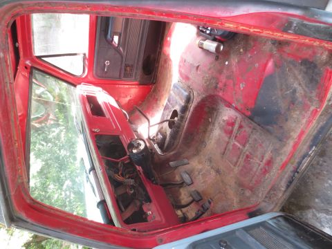 1978 Ford Bronco - The interior of the vehicle is exposed, revealing the floor pan and exposed wiring, suggesting it's undergoing restoration.